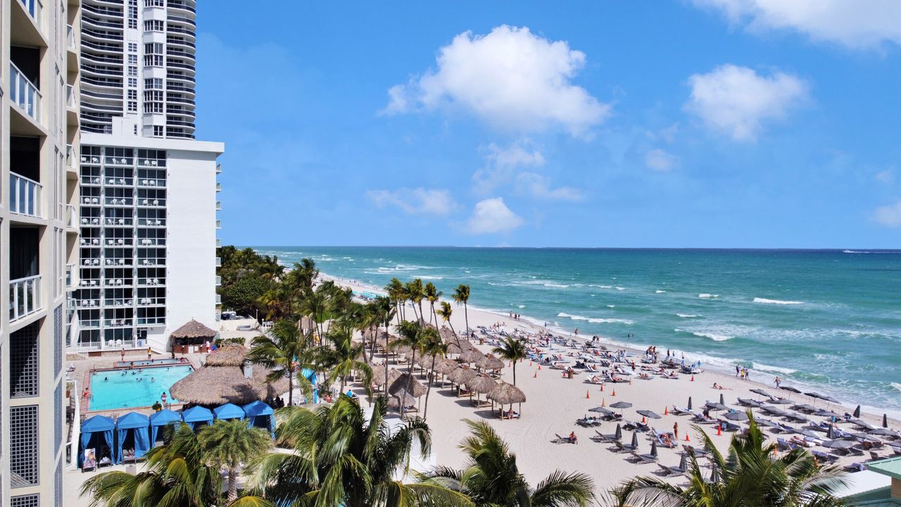 Experience the luxury of Sunny Isles Beach with ocean views, palm trees, and resort amenities.